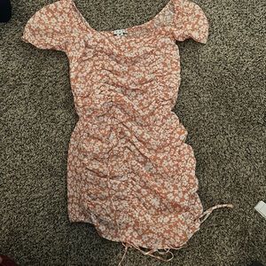 a size medium tight pink dress with white flowers on it.